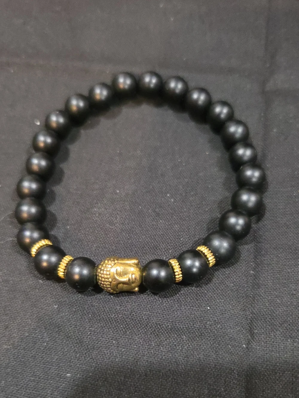 BLACK STONE WITH GOLDTONE BUDDHA BEAD BRACELET